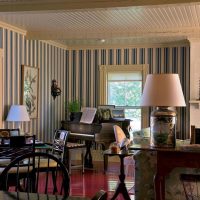 Striped wallpaper in a room with a piano