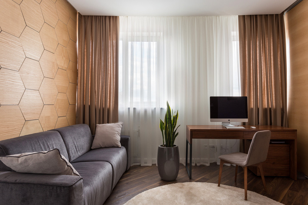 Translucent brown curtains in the living room of a modern apartment