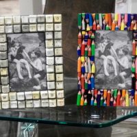 Photo frames of unusual objects on a glass table