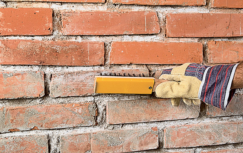 Cleaning the brick wall before painting