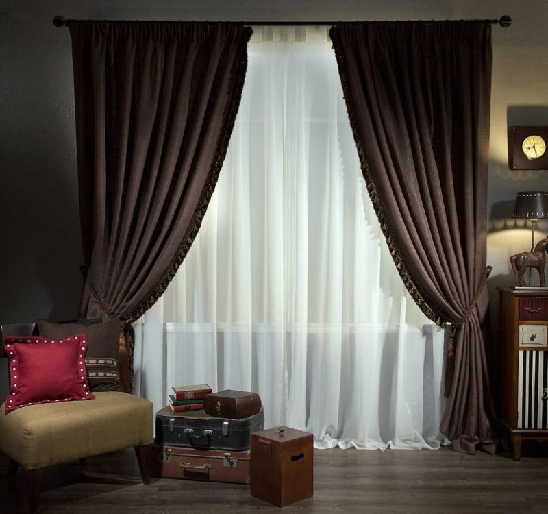 Brown curtains with garters on the window of a stylish living room