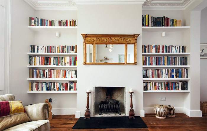 Living room interior with fireplace and bookshelves.