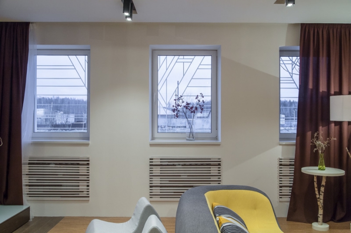 Rack-mounted heating screens in the living room of a private house