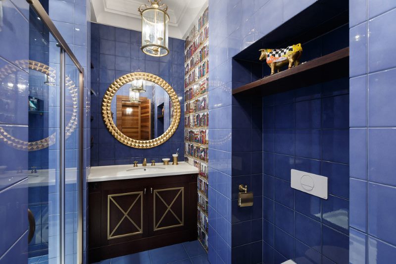 Bathroom interior with blue tiles on the wall.