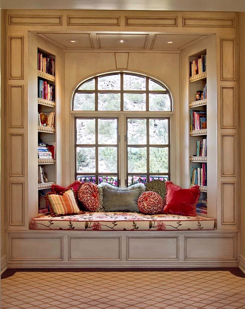 A small sofa for reading books in the window opening