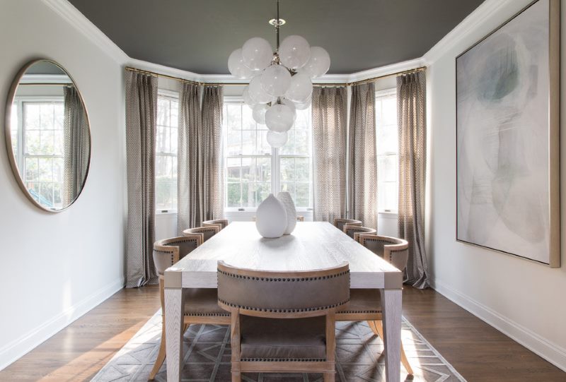 Tan curtains in the interior of a narrow living room