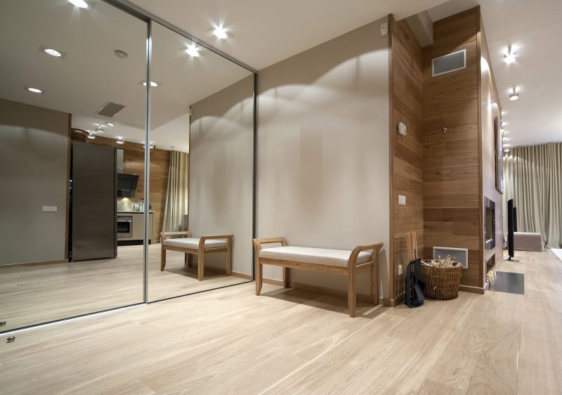 Mirrored wardrobe in the hallway with bright floor