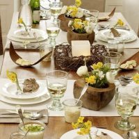 Wooden vases with flowers on the dining table