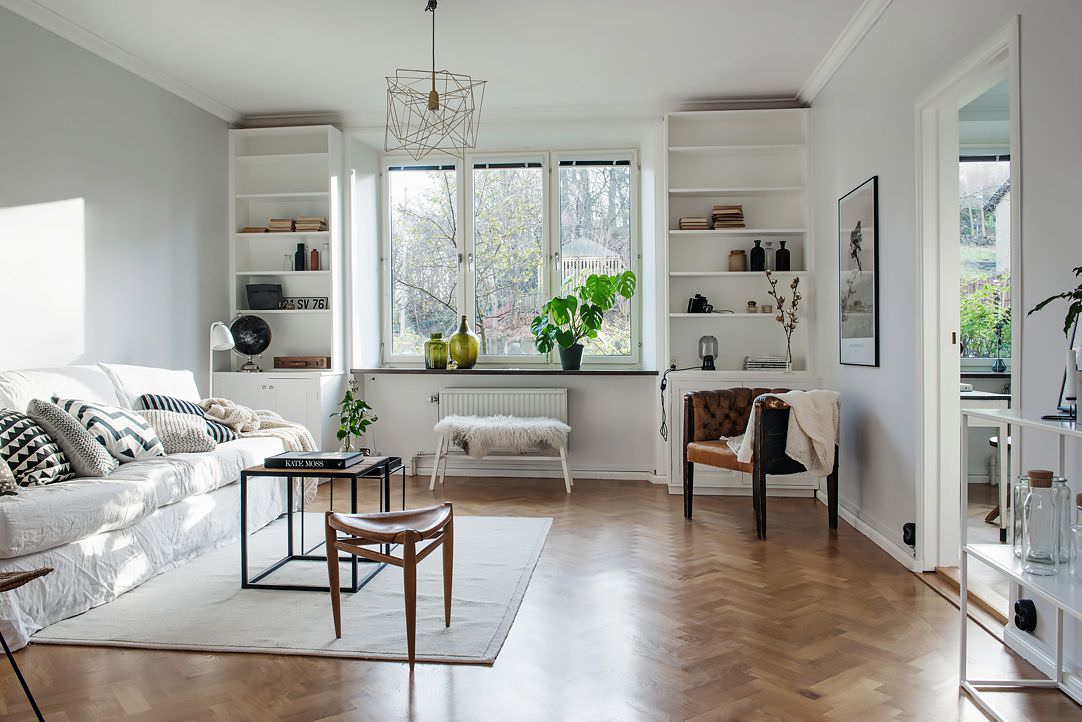 Open white wardrobes in the living room of a private house