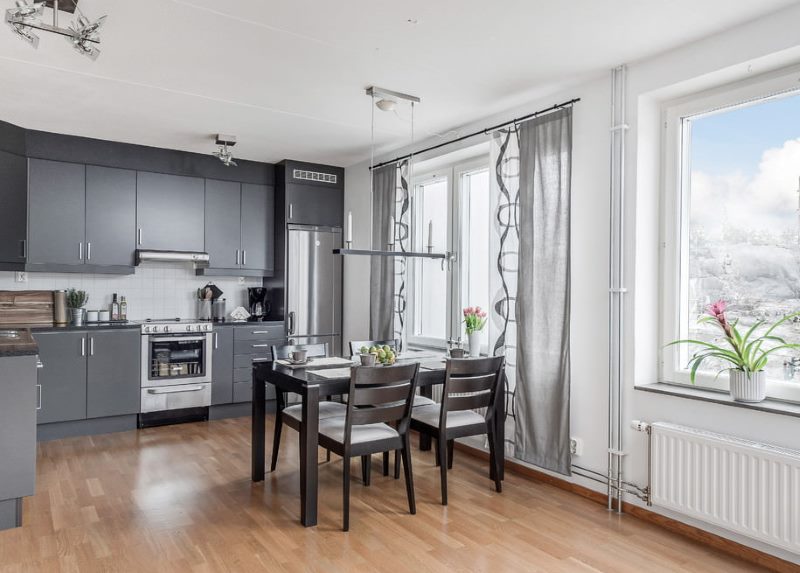 Corner kitchen with gray curtains.