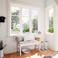 A cup under the bench in the hallway of a country house