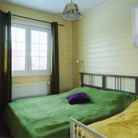 Green bedspread in the bedroom of a private house