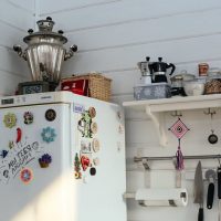 A small shelf on the wall near the refrigerator