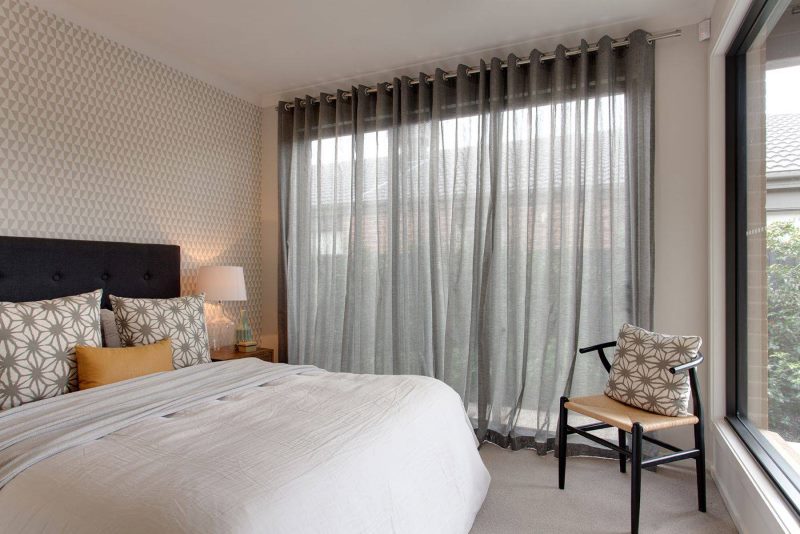 Bedroom interior with light gray curtains