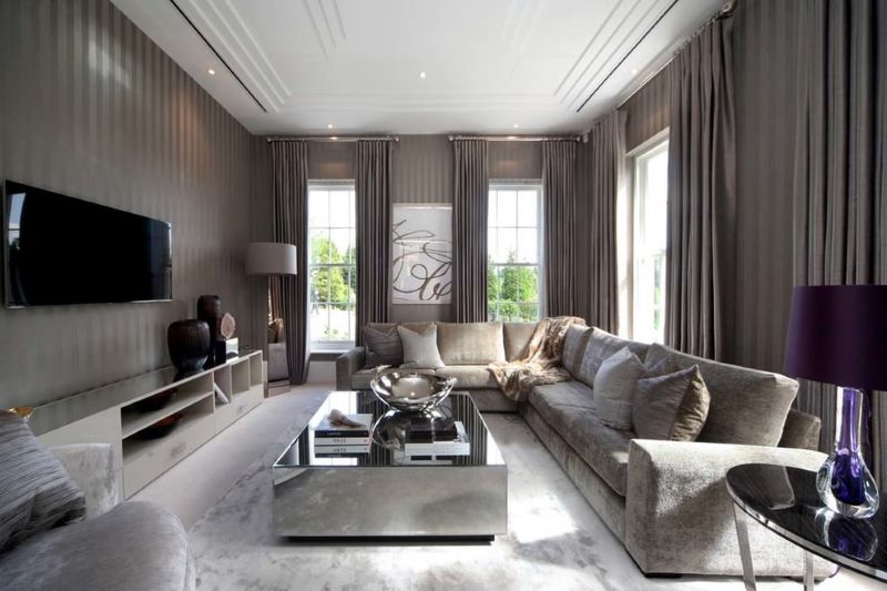 Corner living room interior with gray curtains.