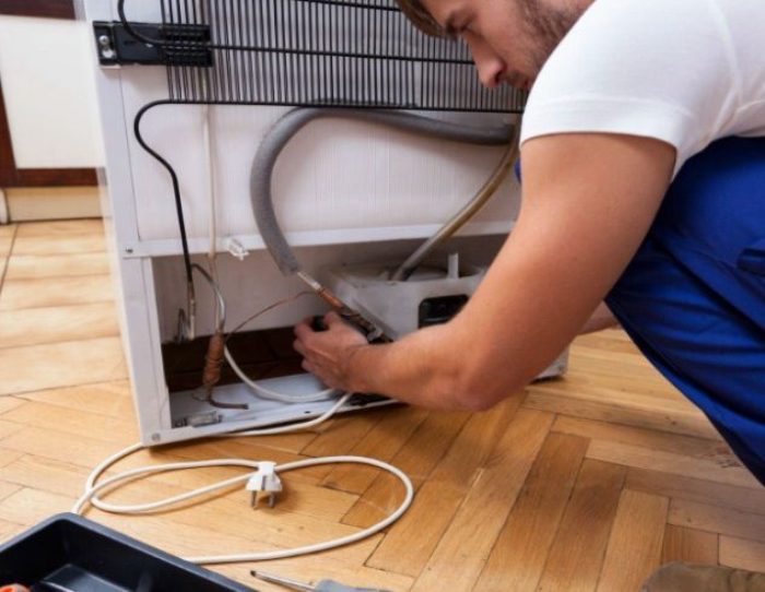 Filling the refrigerator with freon.