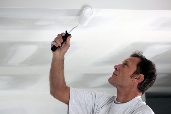 Painting the ceiling in the kitchen.